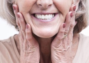 Senior woman smiling with dentures